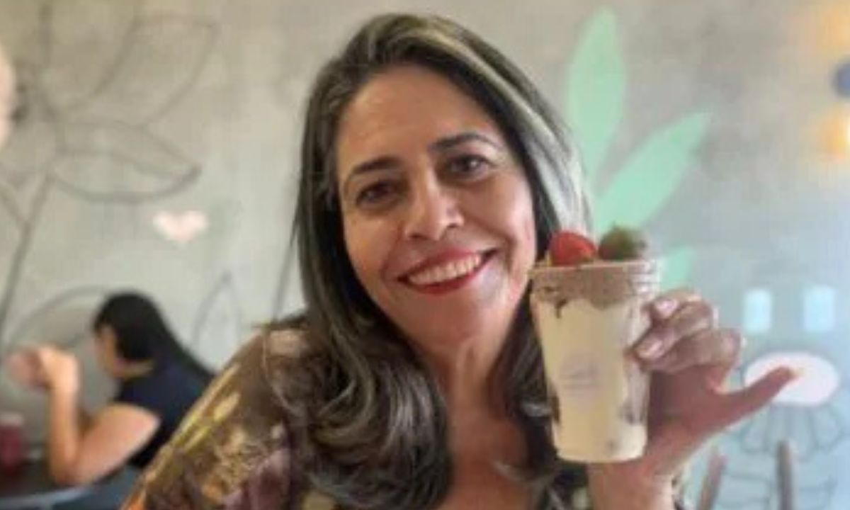 Rosana Maciel Gomes com sobremesa nas mãos, sorrindo